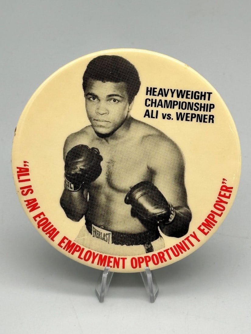 Muhammad Ali vs. Wepner Heavyweight Championship Button: Muhammad Ali vs. Wepner Heavyweight Championship Button: Measures 3.5", "Ali is an equal employment opportunity employer".