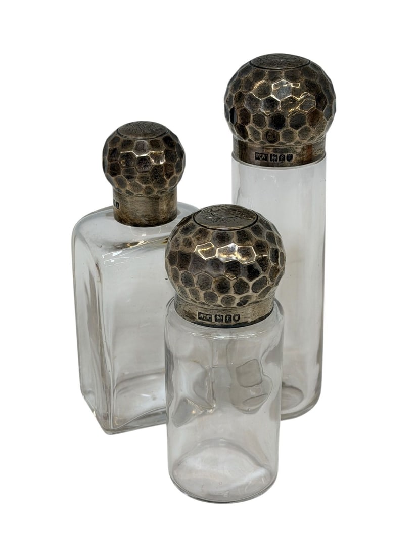 (3) 1901 Mappin and Webb Sterling Silver Hammered Top Glass Bottles: (3) 1901 Mappin and Webb Sterling Silver Hammered Top Glass Bottles: Measuring 4.25", 4.75", 5.75".