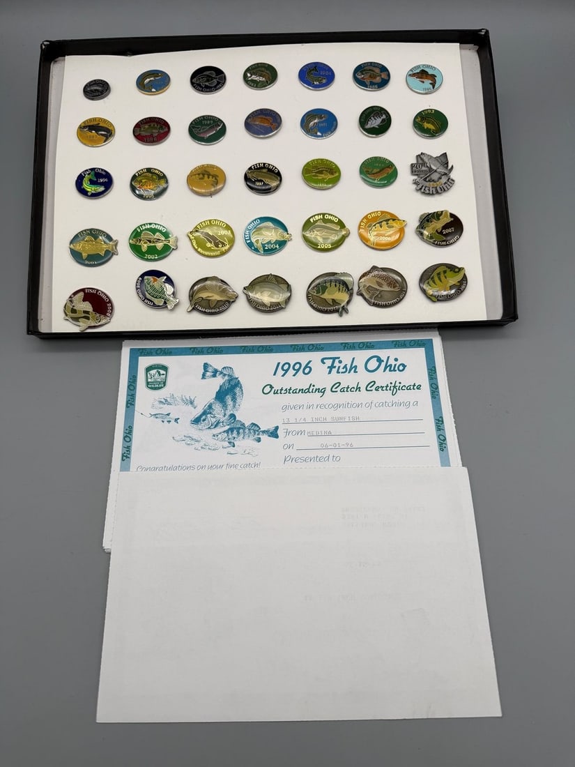 Complete Run of "Fish Ohio Pins" From 1980-2014: Complete Run of "Fish Ohio Pins" From 1980-2014: Incredible group of Fish Ohio pins of 35 years. From 1980 through 2014. Group comes with certificates from 1995-2005. Annual lapel pins awarded by the