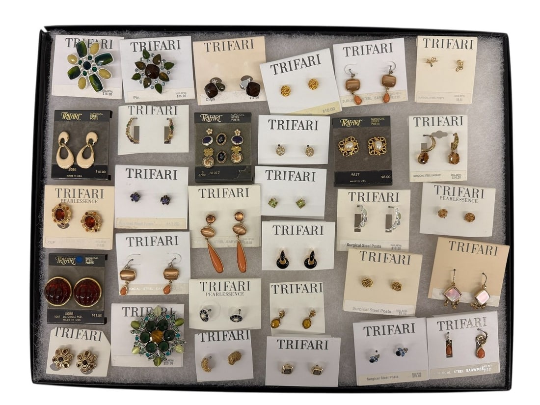 Group of Trifari Earrings and Brooches: Group of Trifari Earrings and Brooches: Includes (31) pairs of earrings, and (3) brooches. All pieces on original cards/tags.