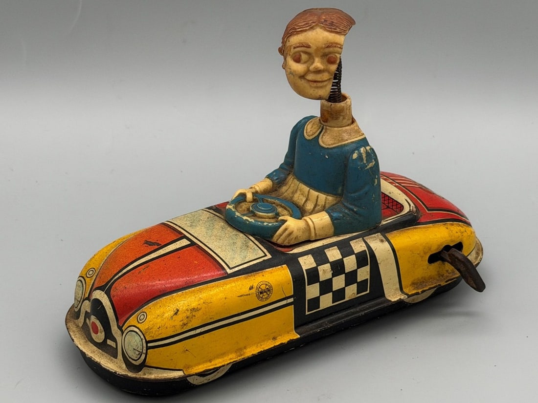 Marx Dipsy Doodle Dora Bumper Car Wind Up: Marx Dipsy Doodle Dora Bumper Car Wind Up: The litho is in good condition. Dipsy missing half of her plastic face and hair.