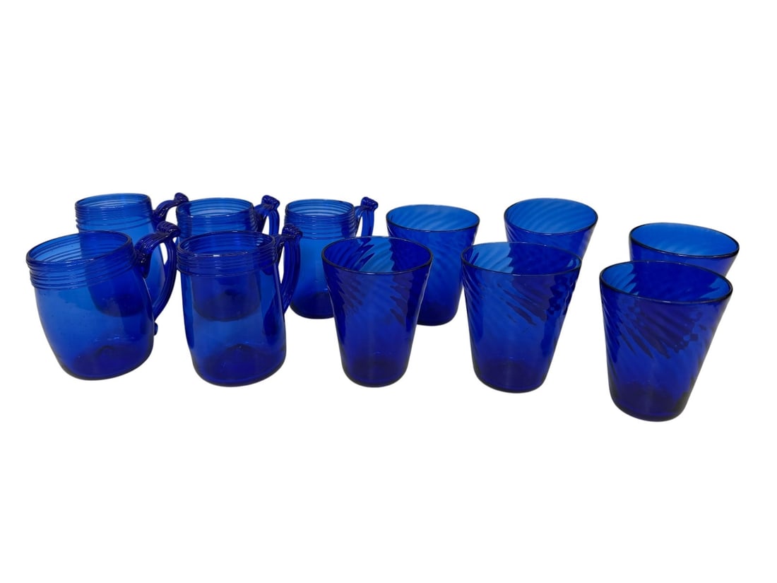 (11) Signed Hand Blown Cobalt Drinking Set: Signed Hand Blown Cobalt Drinking Set: (5) glasses have applied handles, measure between 4 and 4.25" tall.