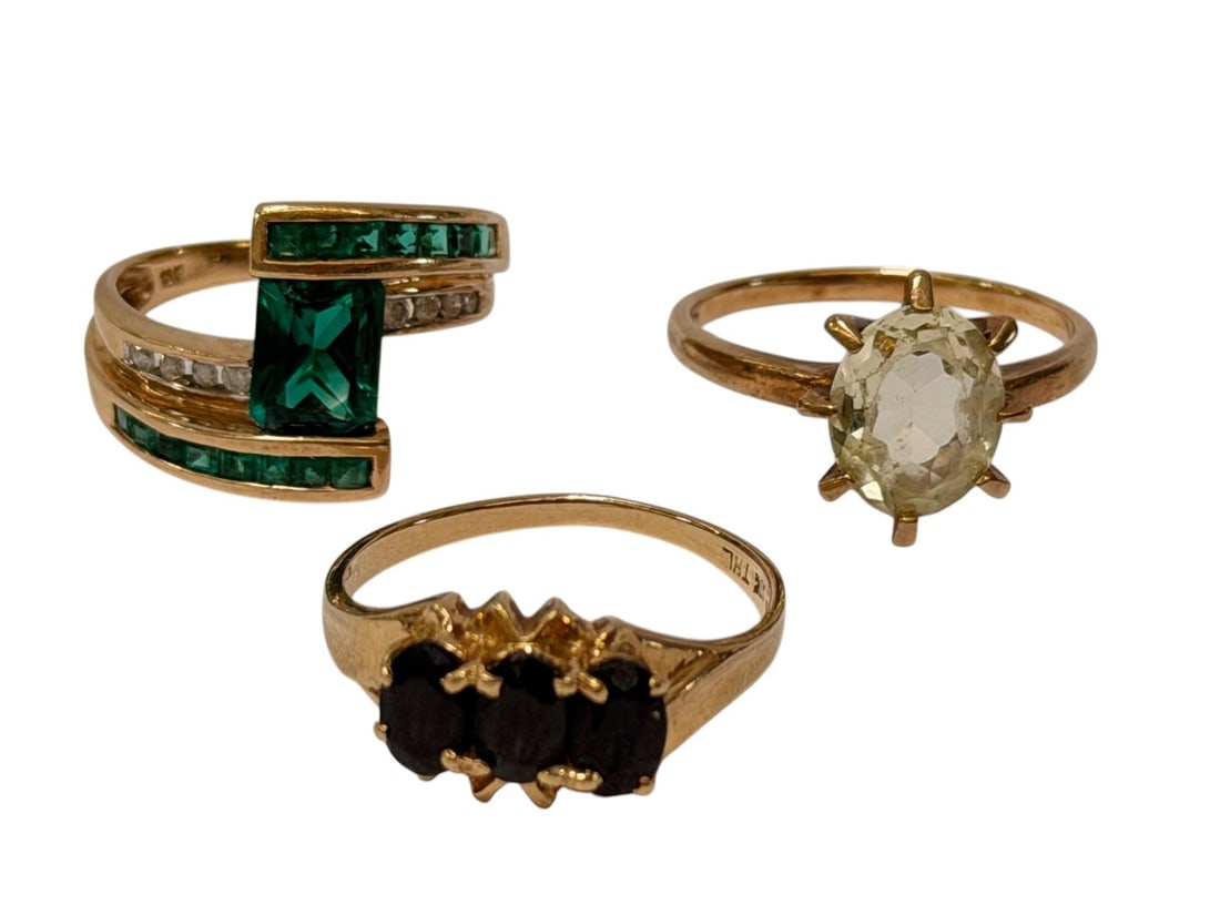 (3) 10k Gold Rings with Emeralds, Hiddenite, Black Onyx: (3) 10k Gold Rings with Emeralds, Hiddenite, Black Onyx: Emerald and diamonds ring has 8 round diamonds, 1 center square emerald 6x8mm and 16 small baguettes. Size 6.5, total weight is 3.87 grams.