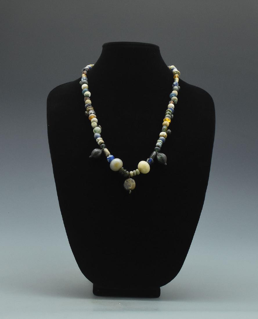 VIKING NECKLACE WITH BEADS: Medieval Viking era necklace with stone and glass beads with silver attachments. Professionally restrung, suitable for contemporary wear. - 640mm, 104 grams - ca.900AD - Property of a Central London g