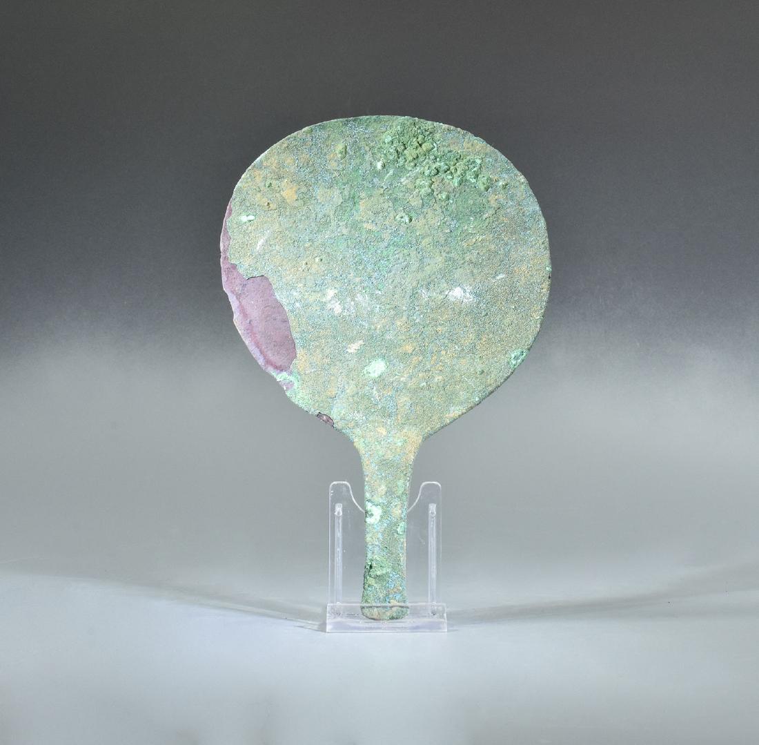 ROMAN BRONZE MIRROR WITH HANDLE: Ca.100 A Beautiful Roman bronze mirror with handle. A beautiful example of a round hand mirror with a slender handle in the form of a stylized lotus flower, its petals opened to embrace the bottom of 