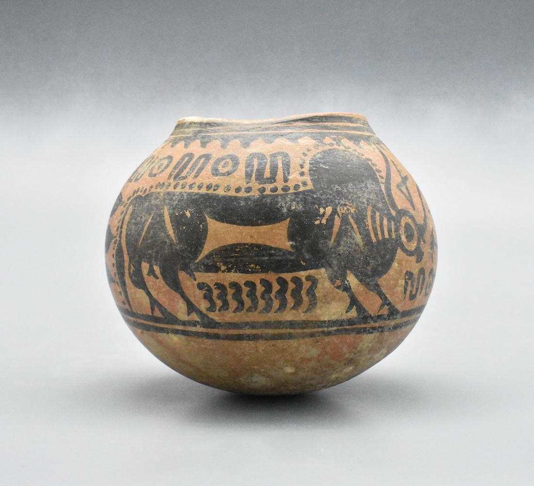 INDUS VALLEY PAINTED VESSEL WITH BULLS: Ca. 3000 – 2000 BC. Superb terracotta storage jar, decorated with zebu bulls and floral patterns. Size: 120 mm (h); 450 grams. Provenance: Important London collection of Ancient art; formed in 1970s