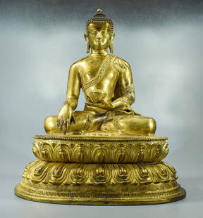 LARGE GILT BRONZE SHAKYAMUNI BUDDHA: Chinese Qing Dynasty gilt bronze seated Shakyamuni Buddha, the founder of Buddhism. Formal in appearance, the Buddha gazes forward with partially closed eyes and the blue-black hair on the head is pil