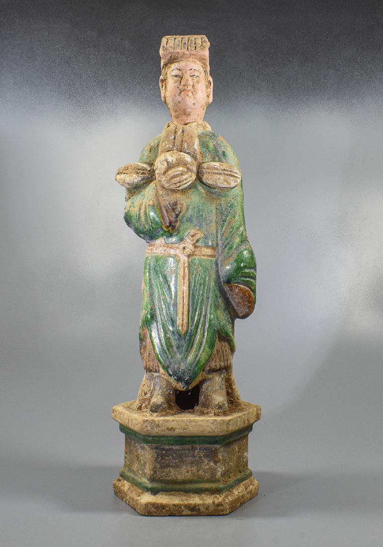LARGE CHINESE MING DYNASTY ATTENDANT FIGURINE: Ca. 1368-1644 AD. Attractive green glazed terracotta figurine. Male attendant figurine, with draped glazed green robes, holding offering box, standing on a lotus flower. Good condition, original glazi