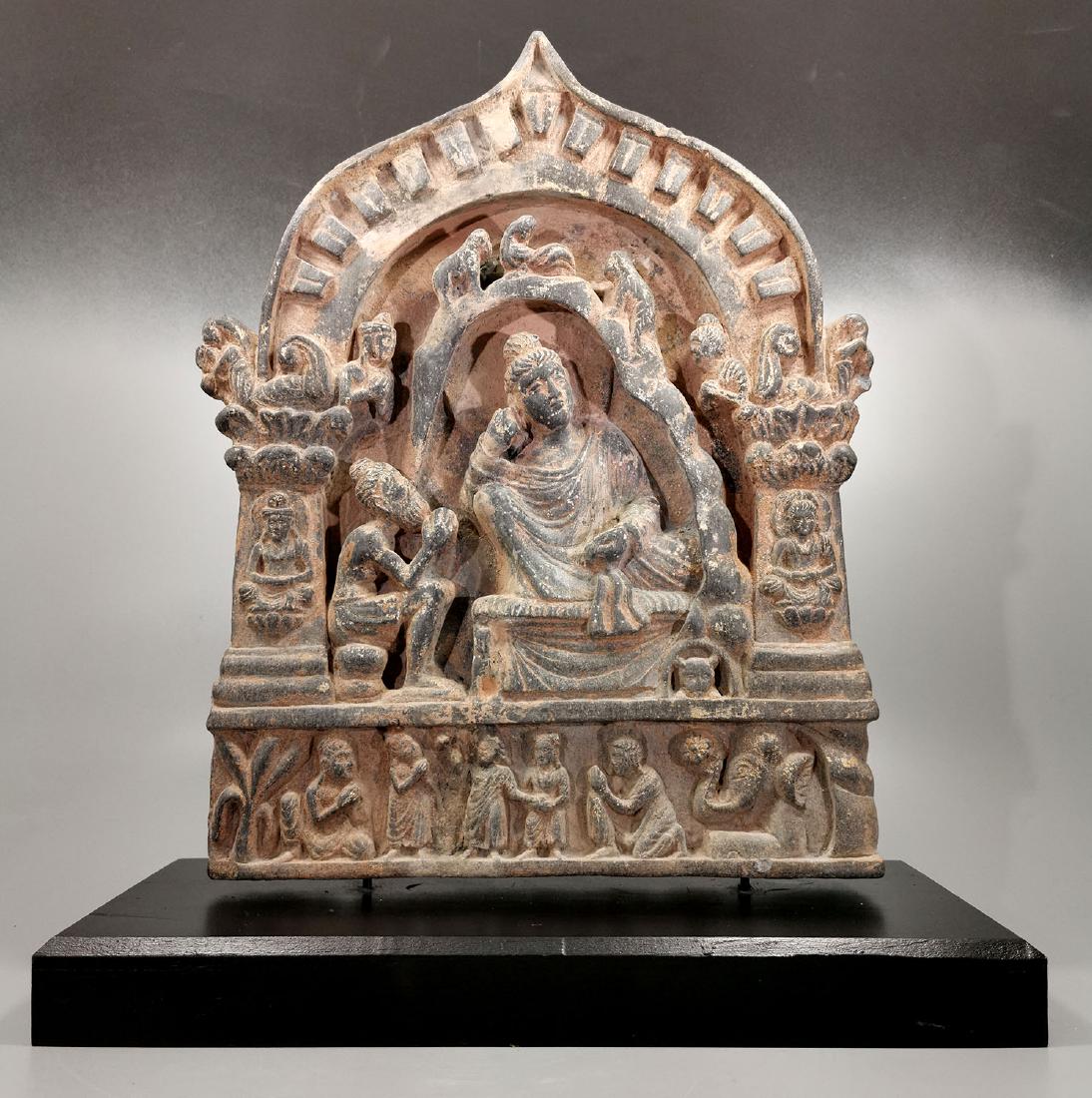 AMAZING GANDHARA SCHIST PANEL OF BUDDHA WITH WORSHIPPER: Ca.400 AD. Amazing Gandhara carved schist stone panel illustrating Buddha seating in a temple, listening to the worshipper standing next to him, enclosed by beautifully carved borders. Good Condition,