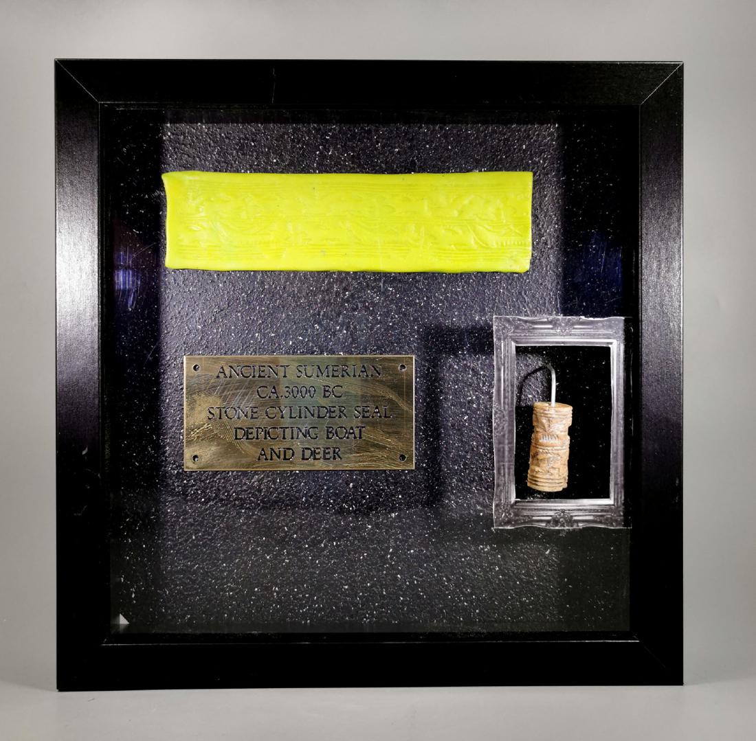 SUMERIAN STONE CILINDER WITH BOAT AND STAG: Ca.3000 BC. Rare Sumerian stone cylinder seal depicting a sailing boat and running stag. With ceramic press and mounted in custom frame. Good Condition; Size frame: 25cm x25cm (9.84 x 9.84 in), Seal s
