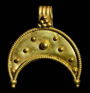 GREEK HELLENISTIC PERIOD GOLD LUNAR PENDANT: Ca.400 BC. Amazing Greek Hellenistic Lunar shape pendant representing the Moon Goddess Luna, decorated with fine granules and a wide finely decorated cylindrical suspension loop. In Greek mythology,