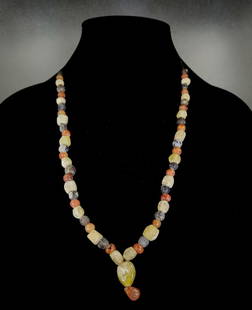 VIKING STONE BEADED NECKLACE: Ca.900 AD. Superb wearable Viking necklace, compromised by multiple coloured stones/glass beads; with central yellow stone as pendant. Good Condition; L:600mm;23.62 in; 68gr; Provenance: Property of