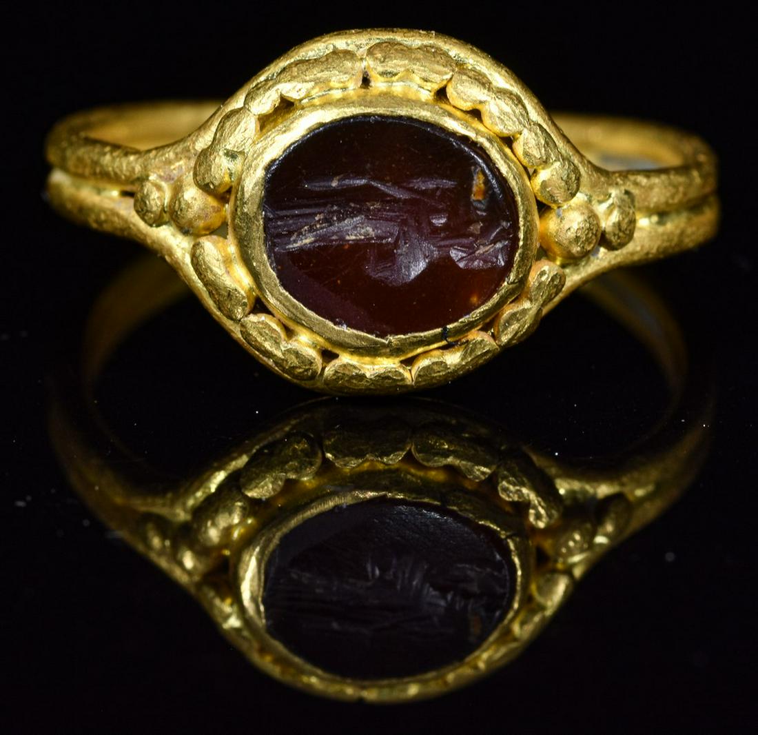 ROMAN INTAGLIO GOLD RING WITH CERES: Ca.200 AD. Wearable Roman gold intaglio ring, It is set with its original dark red carnelian gemstone, simply cut with a stylized image of the goddess Ceres. She holds ears of corn in her left hand an