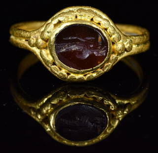 ROMAN INTAGLIO GOLD RING WITH CERES: Ca.200 AD. Wearable Roman gold intaglio ring, It is set with its original dark red carnelian gemstone, simply cut with a stylized image of the goddess Ceres. She holds ears of corn in her left hand