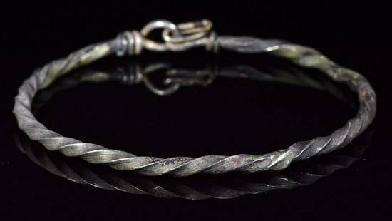 VIKING SILVER TWISTED BRACELET: Ca.900-1100 AD. Beautiful, sturdy and wearable Viking silver twisted bracelet with clasp, consisting of a twisted wire which come together at each terminal where they were hammered and formed into a