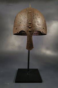 VIKING IRON HELMET WITH NOSE GUARD: Ca. 800 - 1100 AD. Rare medieval four-plate iron helmet with nose guard intacted ; formed of triangular sections; attached with iron rivets passing through this overlap to secure them in position; the