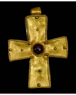 BYZANTINE GOLD CROSS WITH GARNET: Ca.500-700 AD. A hollow Gold cruciform Pendant with hinged suspension loop; central discoid cell with granule detailing and garnet stone insterted. Fine Condition; wearable; Size: 40x30mm; 1.57x 1.18i