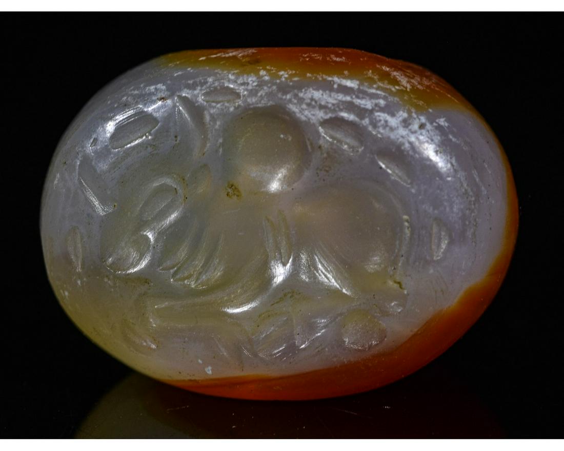 SASSANIAN CARNELIAN BEAD WITH ZEBU BULL: Ca.300 AD. Sassanian Carnelian Bead with a royal zebu bull. Good Condition; Size: 20mmm (0.79 in); 5gr; Provenance: Property of a professional Ancient art and jewelry expert; previously with a London 