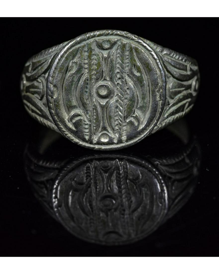VIKING SILVER RING RUNIC SYMBOLS: Ca.900-1100 AD. Interesting wearable Viking Silver Ring with runic symbols, rapresenting the sun in the middle, two stylized ravens under and above the sun and sea serpent on each side- representing t
