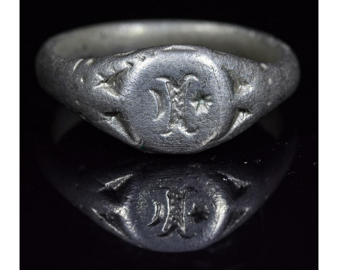 VIKING RING WITH RAM HORNS AND RUNES: Ca.900- 1100 AD. Wearable Viking Silver Ring with circular shaped bezel depicting Ram horns and runic inscription. Stylized snake motif in the ring band. Good Condition; wearable; Inner diameter: 21mm