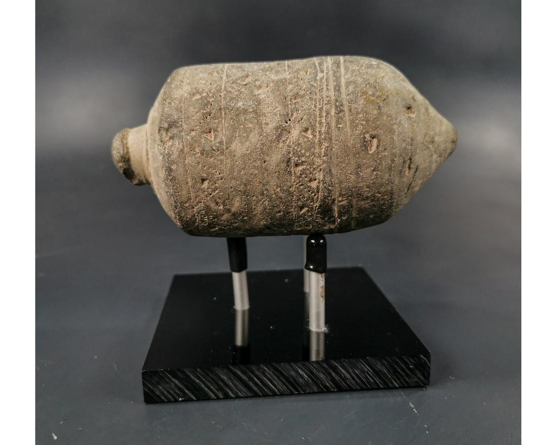 BYZANTINE GREEK FIRE GRENADE ON STAND: Ca.800 AD. A hollow ceramic vessel with barrel-shaped body, domed top and conical base, knop to the upper face for the mouth; Good Condition; Size: L:140mmx70mm;5.51in x 2.76in ; 520gr; Provenance: Pr