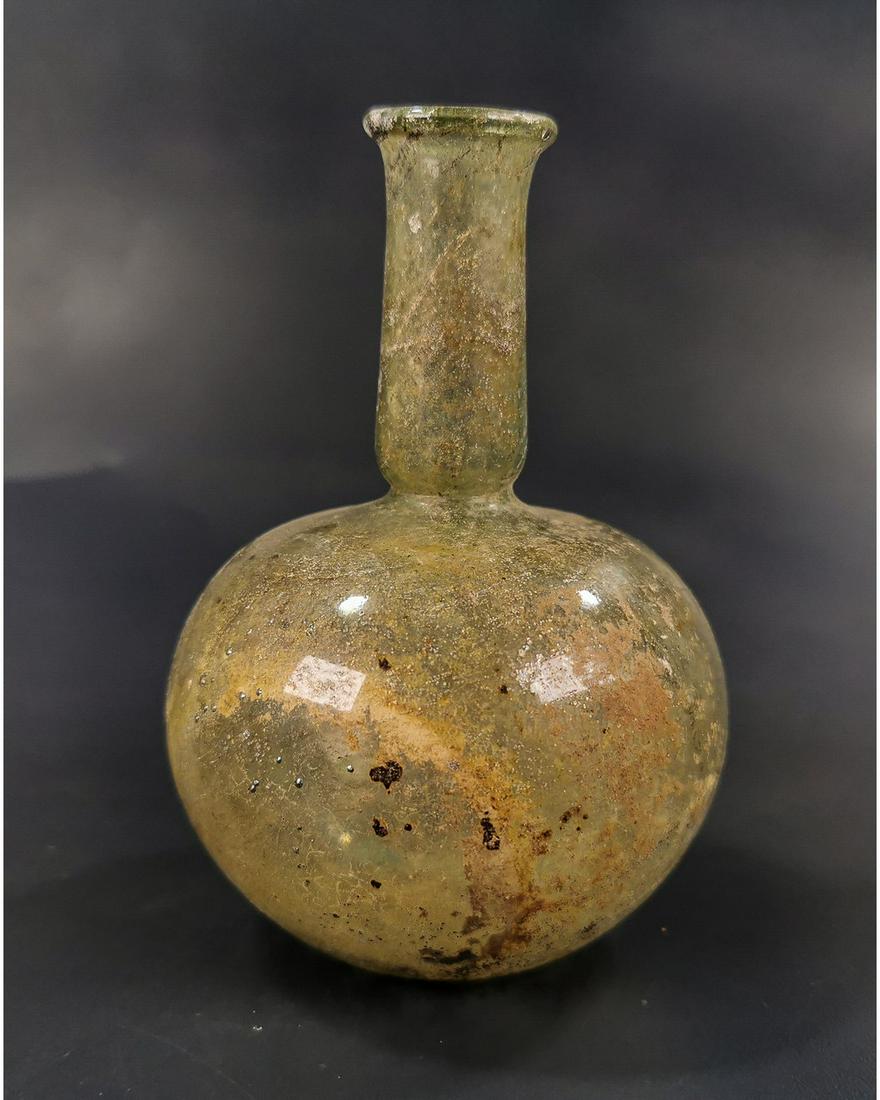 ROMAN GLASS FLASK: Ca.100 AD. Interesting Ancient glass vessel with bulbous body and narrow long neck. Very fine details and colour. Fine Condition; Size: 115x85mm; 4.53inx 3.35in; 40gr; Provenance: Property of a Britis