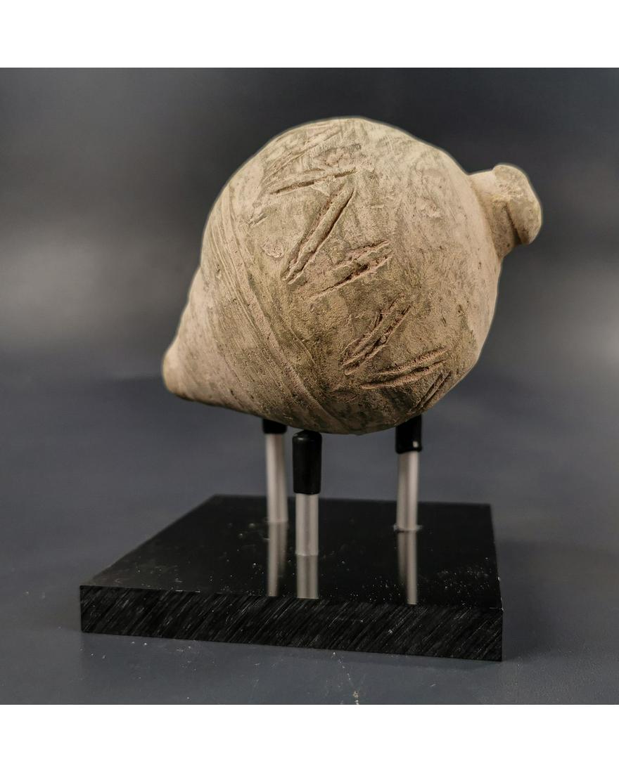 BYZANTINE GREEK FIRE GRENADE ON STAND: Ca.800 AD. A hollow ceramic vessel with barrel-shaped body, domed top and conical base, knop to the upper face for the mouth; Good Condition; Size: L:120mm/85mm; 4.72x 3.35in; (with stand); 475gr; Pro