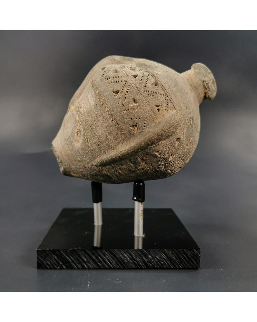BYZANTINE GREEK FIRE GRENADE ON STAND: Ca.800 AD. A hollow Ceramic Vessel with barrel-shaped body, domed top and conical base, the body with a latticework design; knop to the upper face for the mouth; Good Condition; Size: 120x100mm; 4.72x