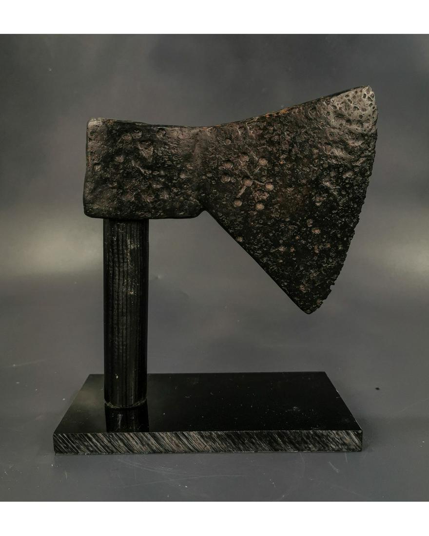 VIKING IRON BATTLE AXE HEAD WITH STAR: Ca. 900 AD. An iron axe head with broad triangular blade decorated with a Star; on custom stand ;150x130mm; 5.91x 5.12in; 860 gr; Provenance: Old British collection of Ancient weaponry, acquired in th