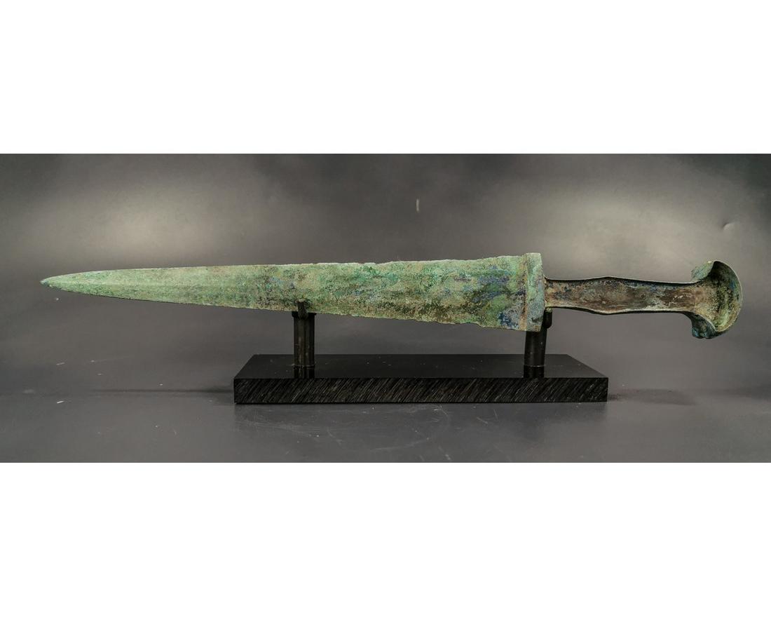 GREEK ARCHAIC PERIOD SWORD WITH HANDLE: Ca. 1600 - 1200 BC. Superb Greek Archaic period decorated short sword with intact handle. A fine example of a lost wax cast bronze short sword with a narrow handle designed to have an inlaid bone or i