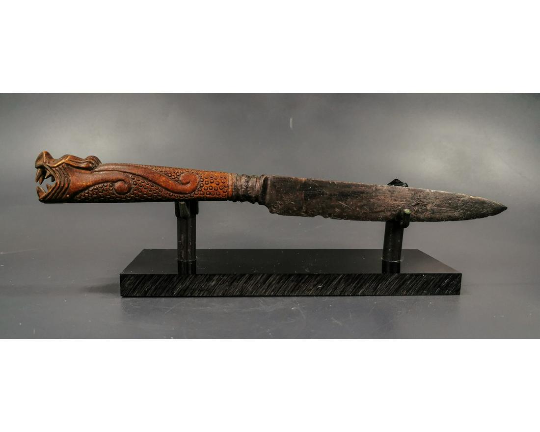 VIKING BATTLE KNIFE WITH DRAGON FAFNIR HANDLE: Ca. 900 AD. Medieval, long and thin knife, expertly cleaned and conserved; professionally reconstructed, hand carved bone handle depicting the mythological dragon – Fafnir; including custom made sta