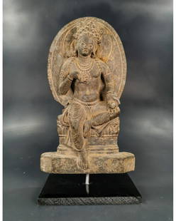 GANDHARA SCHIST RELIEF FIGURE OF A SEATED BODHISATTVA: Ca. 200 AD. Amazing Gandhara Panel depicting a seated Buddha In meditation pose; seated in the lotus flower; halo behind his head, fine facial details, moustache, wavy hair, wearing a necklace. The ar