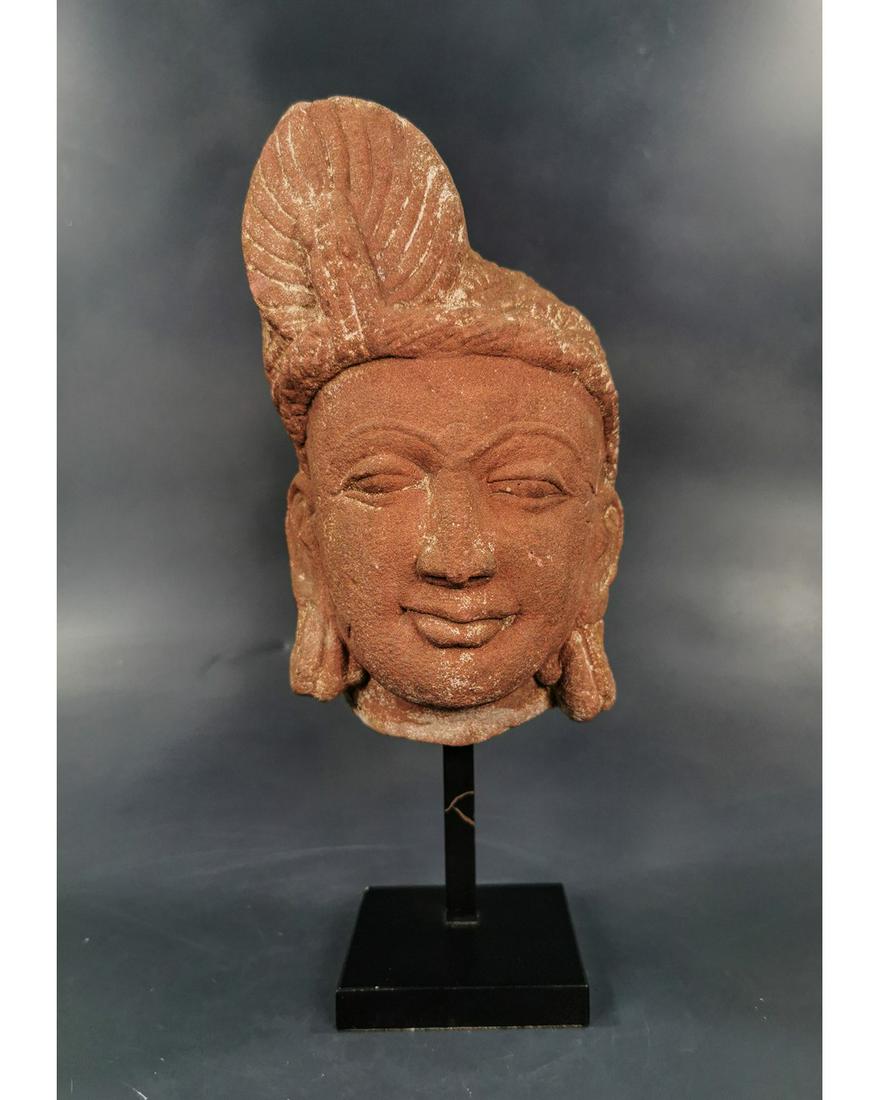 MEDIEVAL INDIAN STONE HEAD OF PRINCESS: CA.1100 AD. Lovely decorated Red Stone Head, with fine features, wearing a tall royal headdress.Good Condition, on custom made stand; Size: 260x110mm; 10.24x 4.33in; 2250gr; Provenance: Private collec