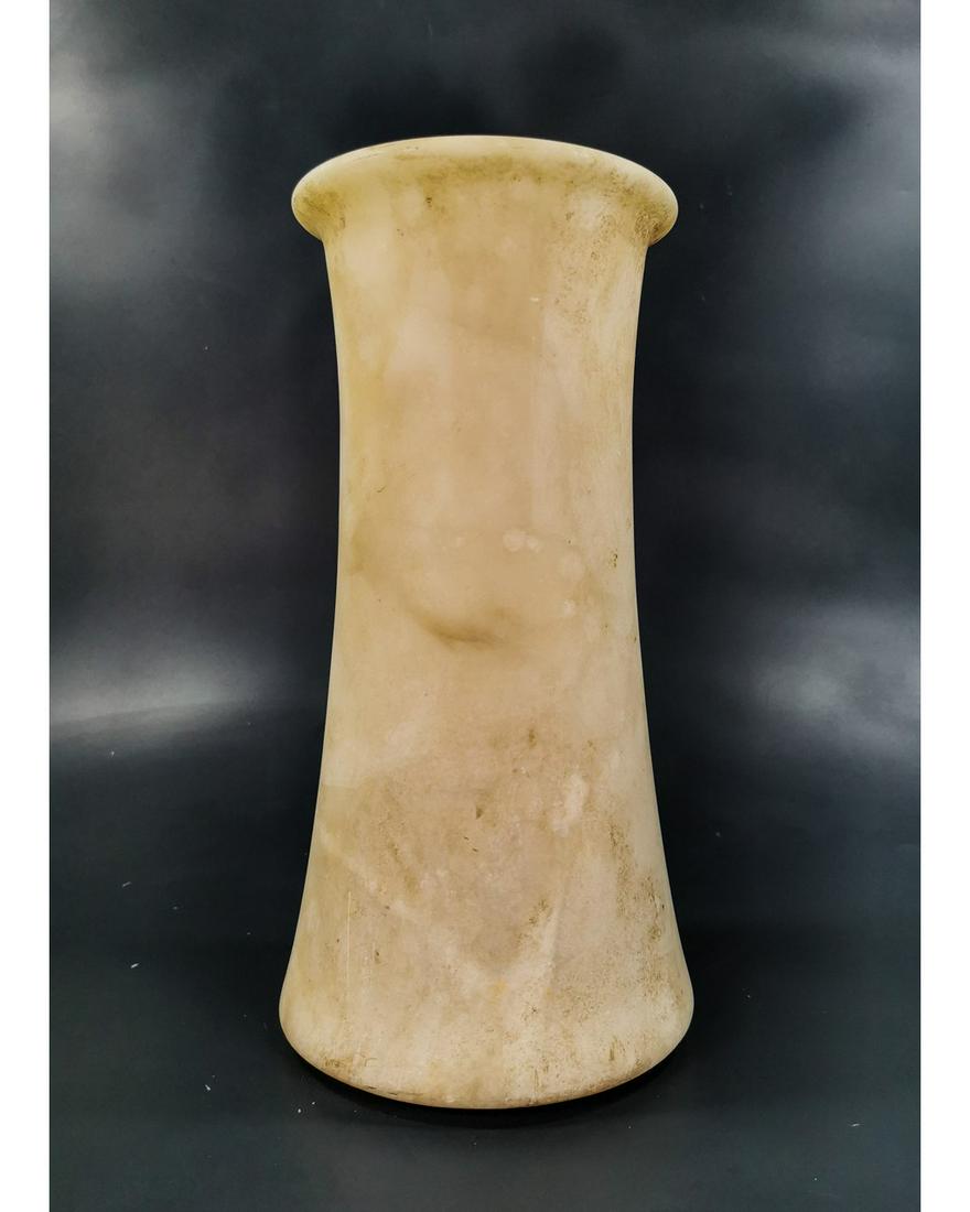 BACTRIAN ALASBASTER TALL VESSEL: CA.3000-2000 BC.Attractive Bactrian Alabaster Vessel in Cylindrical form, flaring to the slightly rounded base, with an overhanging rounded disc rim. Size:300x135mm; 11.81x 5.31in; 3.750gr; Provenance