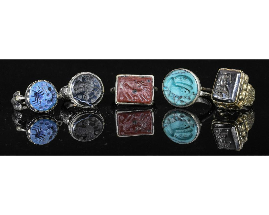 COLLECTION OF MIDDLE EASTERN TRIBAL INTAGLIO RINGS: Ca.19TH - 20TH C AD. Wearable collection of Post Medieval Tribal / Yemeni white metal intaglio rings with multiple depictions and different types of gemstones. Fine Condition; D:18-24mm/L:30-35mm;56gr