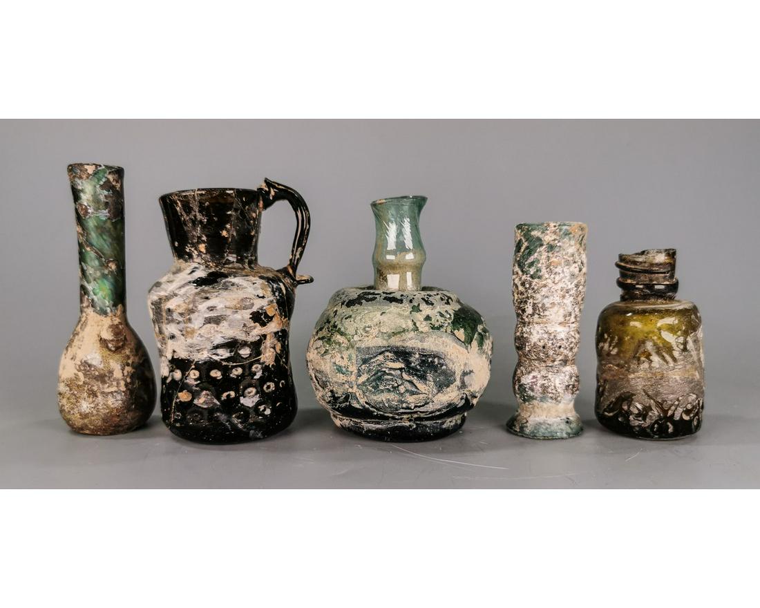 COLLECTION OF ROMAN GLASS BOTTLES: Ca.100-700 AD. Collection of Roman and later period glass vessels in various shapes; sizes and colours; Good Condition; minor repair in some of the vessels; Size: 80-110mm3.15-4.33in ; 555gr; Provenan