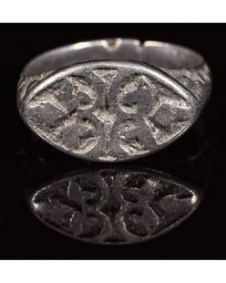 MEDIEVAL SILVER RING WITH FLEUR DE LIS: CA. 1200 AD Crusaders period silver ring; composed of a round-shaped hoop; forming an elliptical bezel; decorated shoulders; the bezel depicts Fleur-de-Lis pattern; possibly owned by a French Knight.