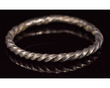 VIKING SILVER TWISTED RING: CA. 900 AD Rare Viking period silver ring; composed of a single twisted rod. Good, wearable condition; D: 23mm/W:28mm;2.5gr; Provenance: Property of a Harlow town professional; previously in a 1990s