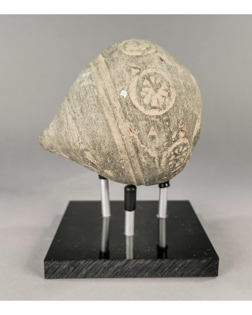 BYZANTINE GREEK FIRE GRENADE ON STAND: Ca.800 AD. A hollow ceramic Vessel with a barrel-shaped body, domed top, and conical base, knop to the upper face for the mouth; Good Condition; L:115mm/W:90mm;4.53/3.54in; 520gr; Provenance: Private