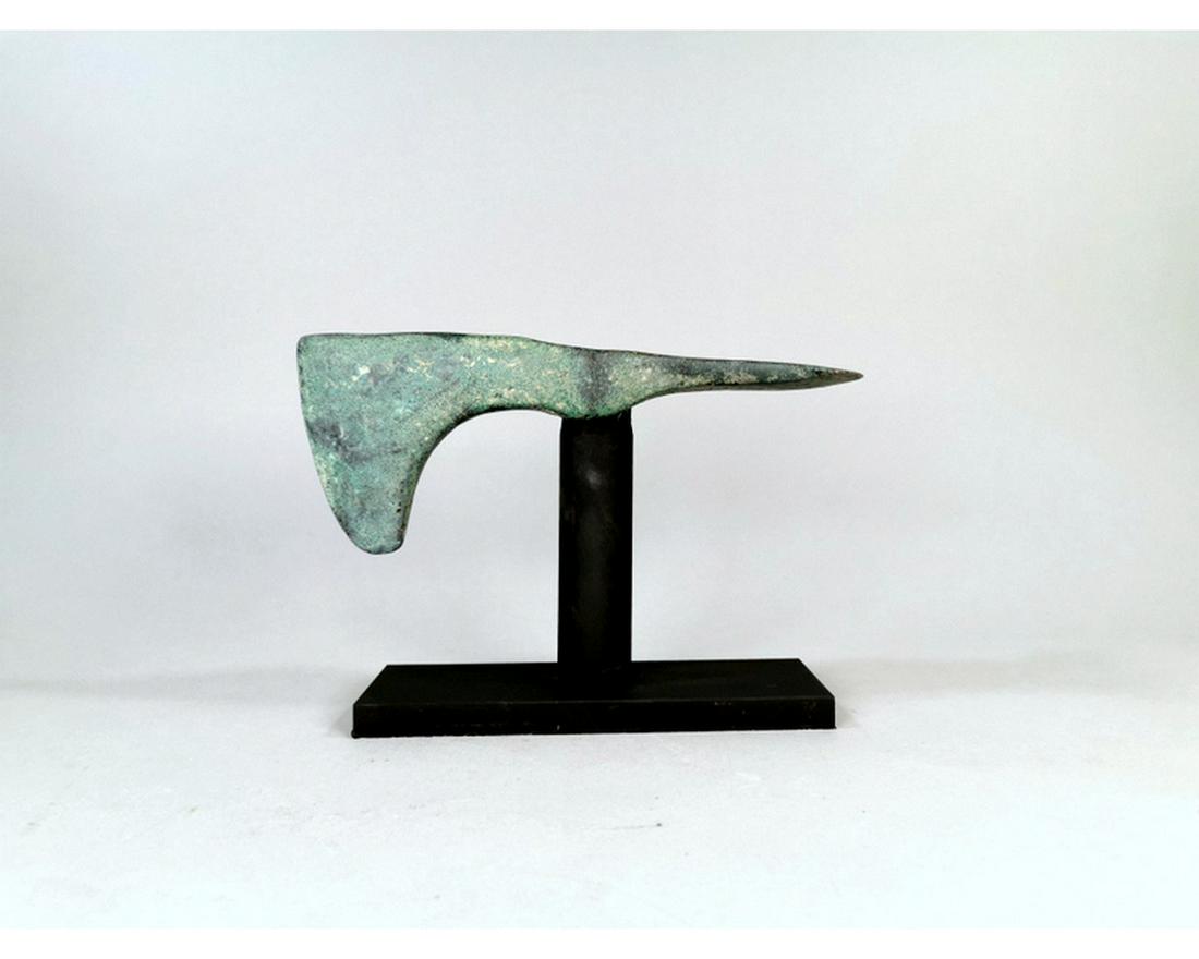 RARE LARGE BRONZE BATTLE AXE: Ca. 1250 - 650 BC. A cast Luristan axe head comprising a tubular socket flared adze to one side and axe blade to the other; supplied on a custom-made stand. Superb condition, green smooth patina.H:150