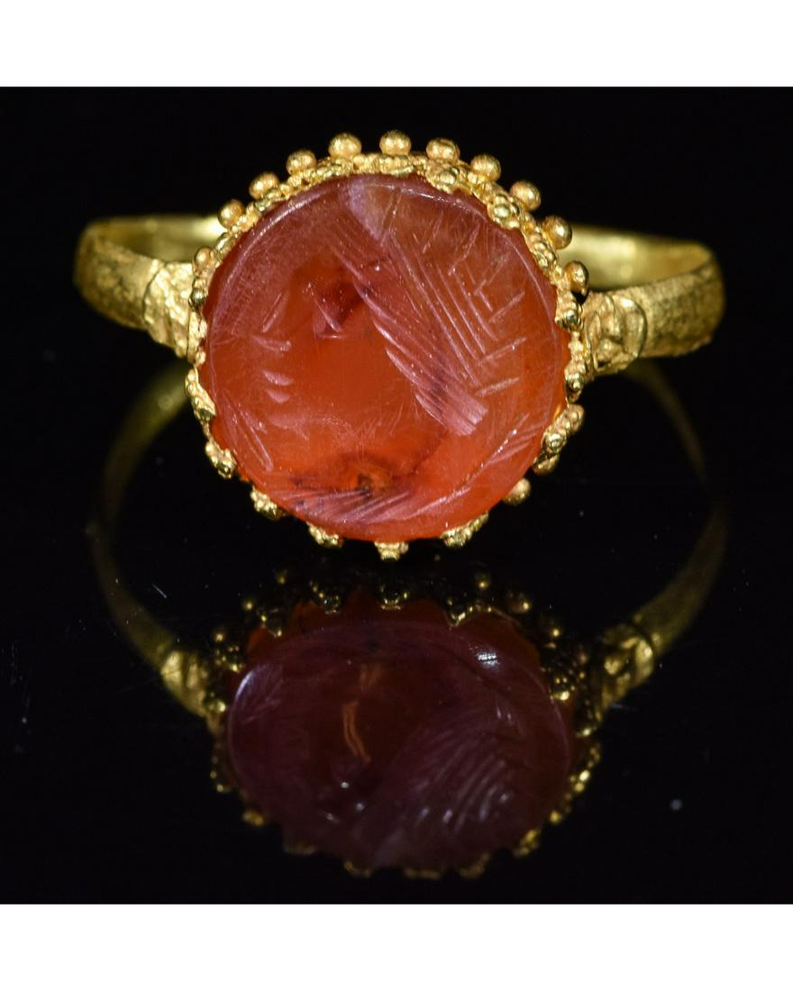ROMAN GOLD INTAGLIO RING WITH JUPITER: Ca.100 AD. A really nice Roman wearable gold ring formed by around band; circular-shaped bezel with intaglio insert depicting god Jupiter; Fine condition; wearable; ; D:20mm/L:22mm UK SIZE V; US SIZE 
