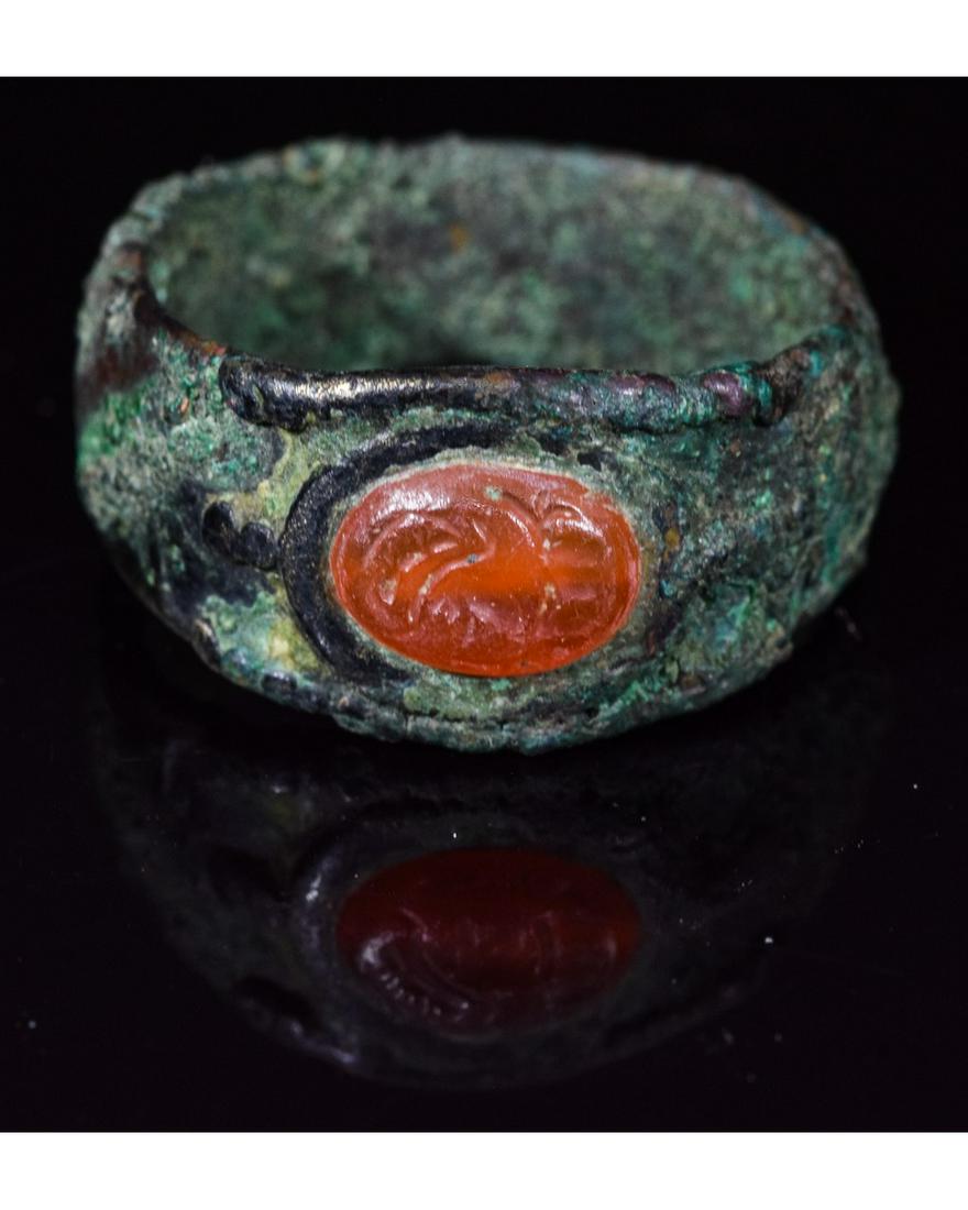 SASSANIAN ROYAL INTAGLIO BRONZE RING: Ca. 350 AD. Important Sassanian bronze intaglio ring depicting a Royal figure on a beautiful stone; Good condition; wearable; ; D:19mm/L:22mm UK SIZE T; US SIZE 9; 6.5g; Provenance: Property of a Lond