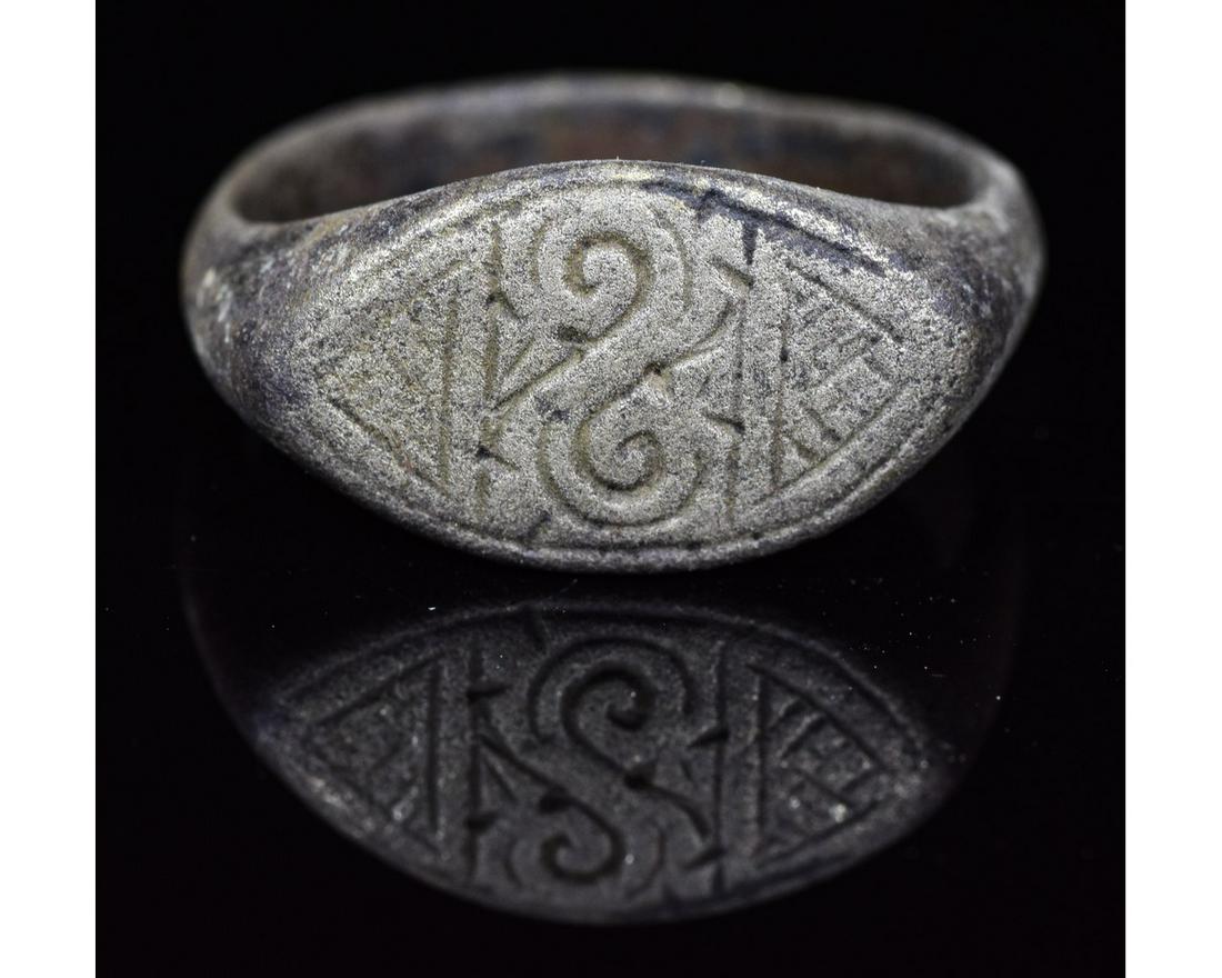 VIKING AGE SILVER RING WITH SYMBOL: Ca.900 AD. An interesting medieval ring with lozenge-shaped bezel engraved with runic symbols. intact and well-preserved band. Possibly worn by a Viking priest or warrior. Reference for Viking Jewelle