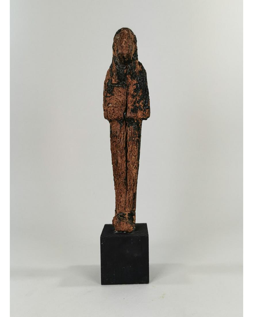 EGYPTIAN WOODEN USHABTI ON STAND: Ca. 1320 -1200 BC. Ancient Egypt, New Kingdom period, 19th Dynasty, A nice Egyptian figure, tall, and hand-carved wooden USHABTI with a wonderful form displaying a myriad of fine details. The figure s