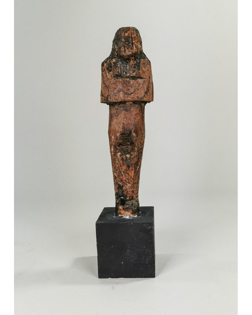 EGYPTIAN WOODEN USHABTI ON STAND: Ca. 1320 -1200 BC. Ancient Egypt, New Kingdom period, 19th Dynasty, A nice Egyptian figure, tall, and hand-carved wooden USHABTI with a wonderful form displaying a myriad of fine details. The figure s