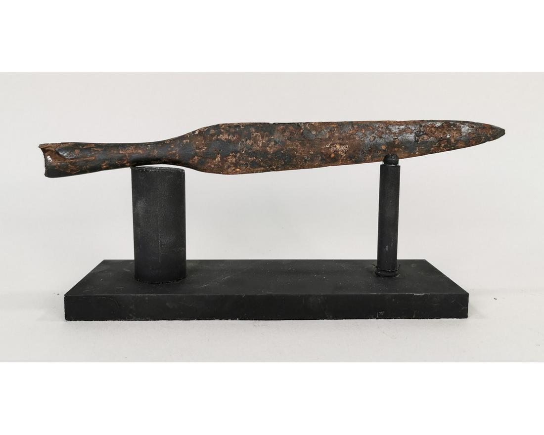 ROMAN IRON CAVALRY SPEARHEAD: Ca. 100 – 300 AD. An iron Roman cavalry spearhead comprising a slender leaf-shaped lentoid-section blade with raised midrib and short neck, tapering shaft with a hole for fixing stud; mounted on a c