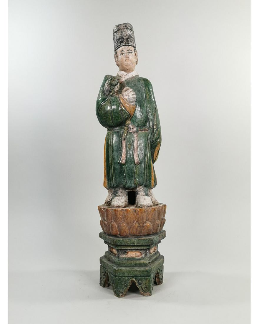CHINESE MING DYNASTY TERRACOTTA FIGURINE: Ca. 1368-1644 AD. Amazing green glazed terracotta figurine. Male attendant figurine, with draped glazed green robes, holding offering box on a lotus flower. Good Condition; 545 x 140 mm; 21.45665x5.51