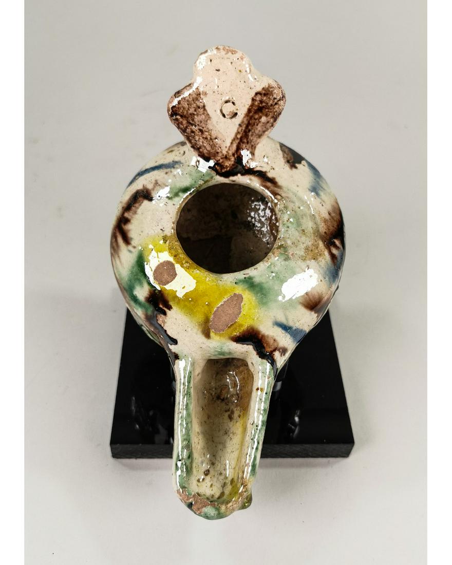 SELJUK GLAZED OIL LAMP: Ca.1000 AD Medieval Islamic terracotta glazed clay molded oil lamp with geometric design relief and multicolor glaze characteristic of the Persian artisans with handle. Used more than a thousand years