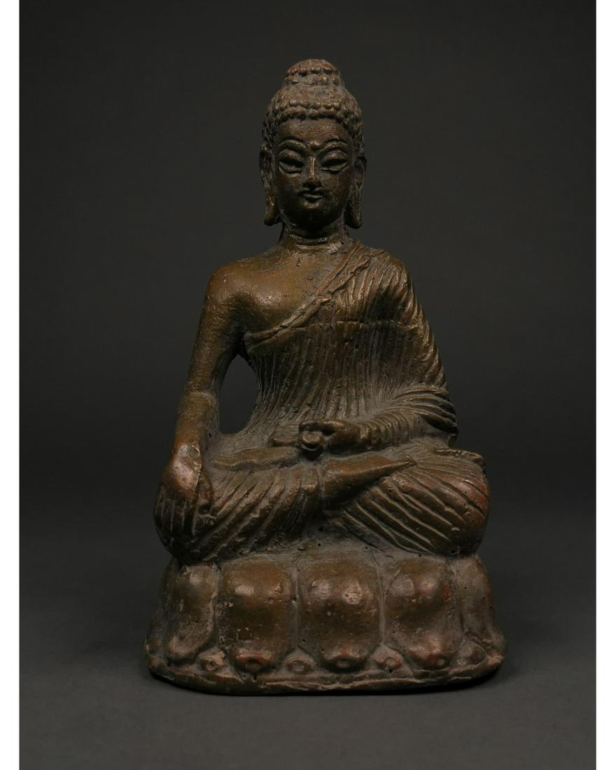 GANDHARA BRONZE BUDDHA FIGURINE: Ca.100-300 AD(Ancient Region of Gandhara; Modern day Pakistan, Afghanistan) An attractive bronze figurine of Shakyamuni Buddha, seated on a lotus position; the hands on the bhumisparsha mudra, with it