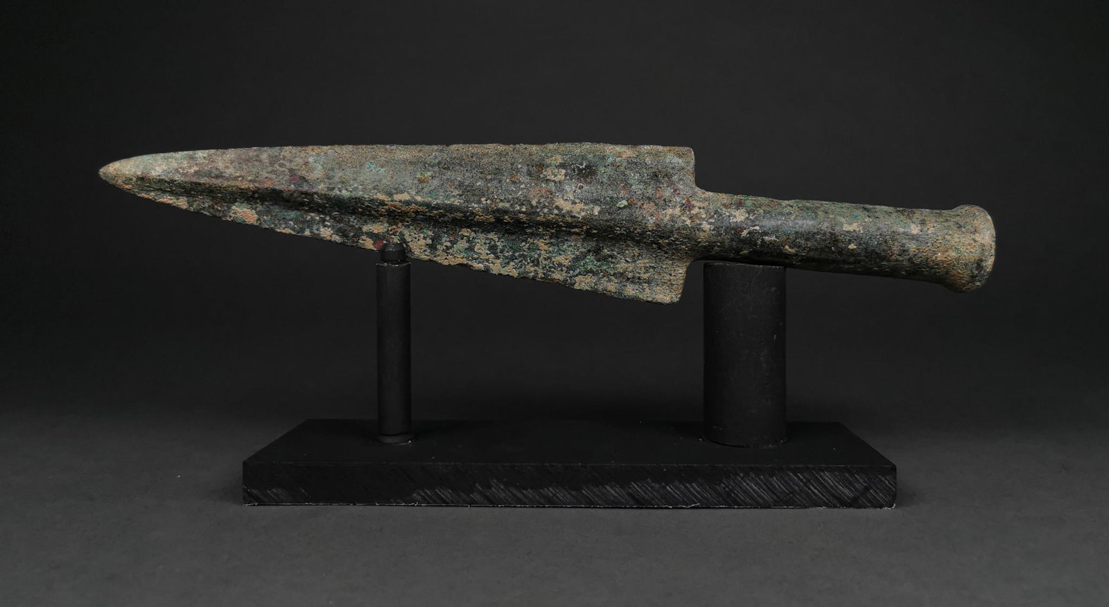 RARE ANCIENT GREEK HOPLITE BRONZE SPEAR: 800 – 600 BC, Greek Hoplite Period. A Bronze spearhead with a triangle-shaped, lentoid-section blade with a raised midrib and medium length socket. Beautiful Patina. From west Asia to Mainland Greec
